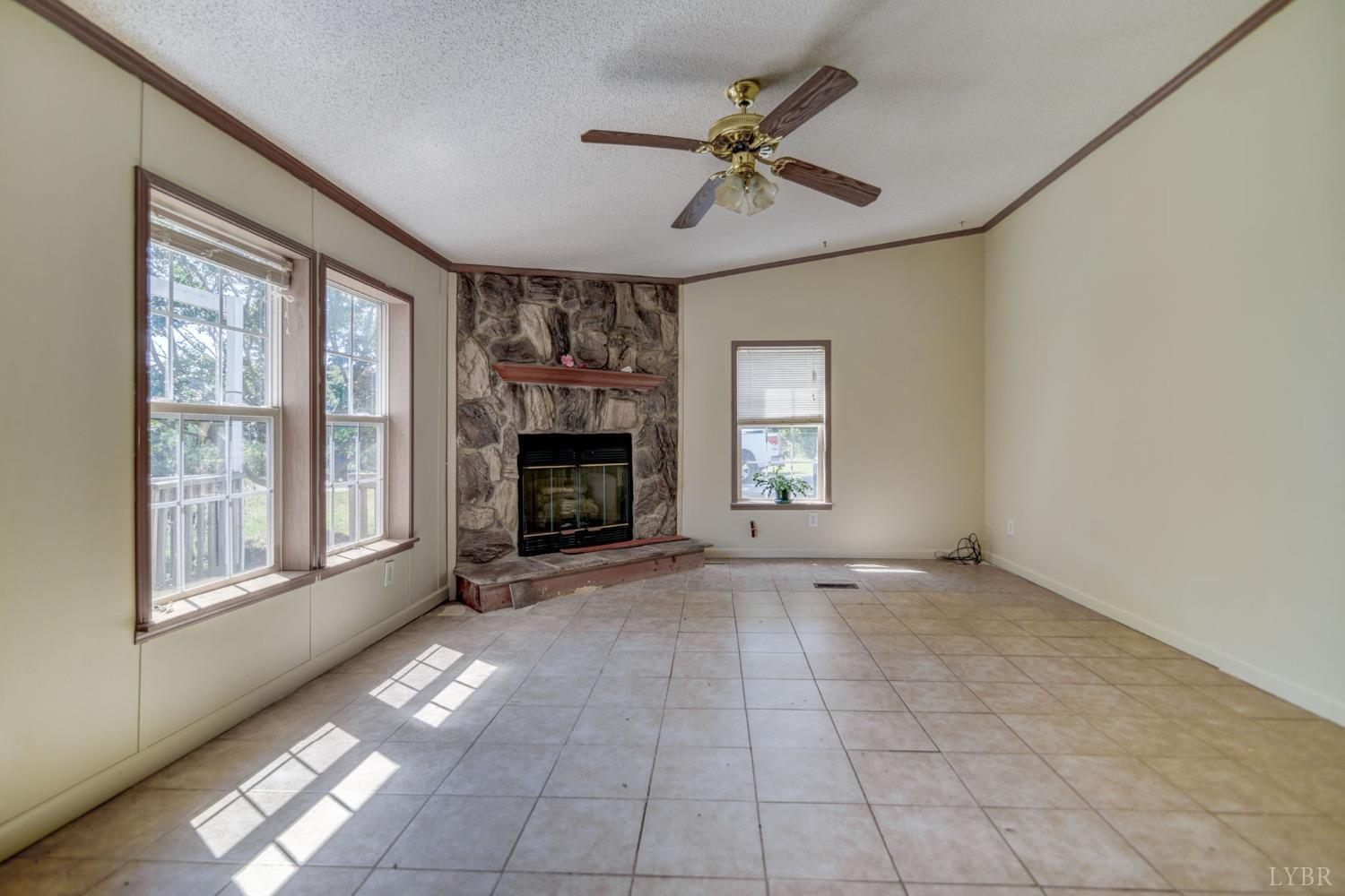 349 Theta Mill Road Gladys, VA 24554 - Photo 8 of 48 a view of empty room with fireplace and windows
