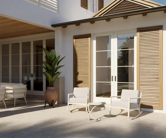 a view of a patio with a table and chairs and potted plants