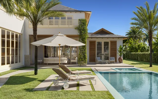 a view of a house with swimming pool and sitting area