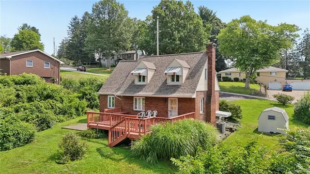 an aerial view of a house with a yard table and chairs