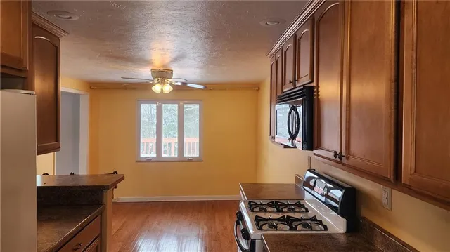 a kitchen with stainless steel appliances a stove and a refrigerator