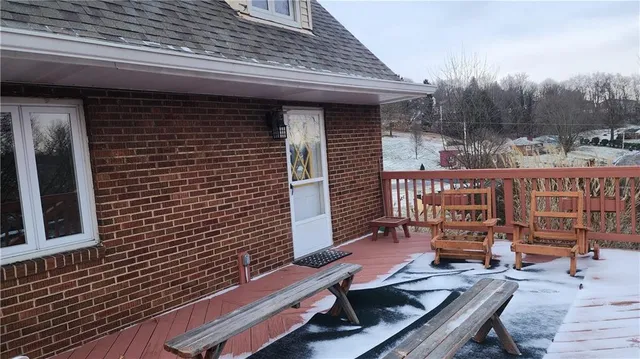 a brick building with a door and a chair