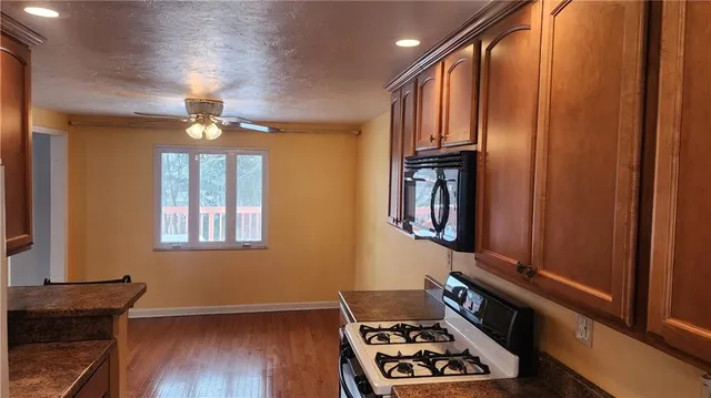 a view of an entryway with wooden floor