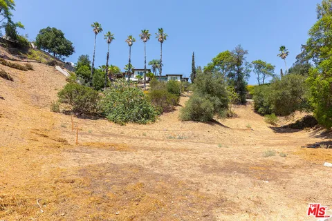 a view of a garden with a building in the background