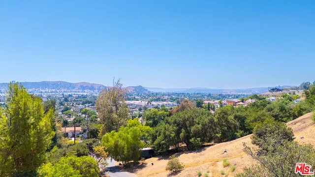 a view of a city with lush green forest