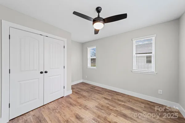a view of an empty room with wooden floor