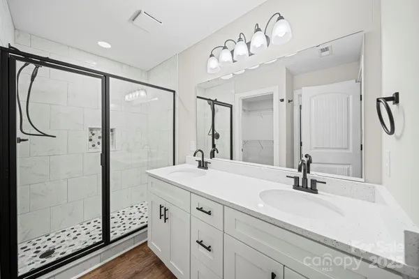 a bathroom with a double vanity sink mirror and double