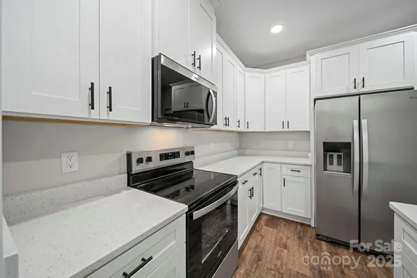a kitchen with a stove microwave and refrigerator