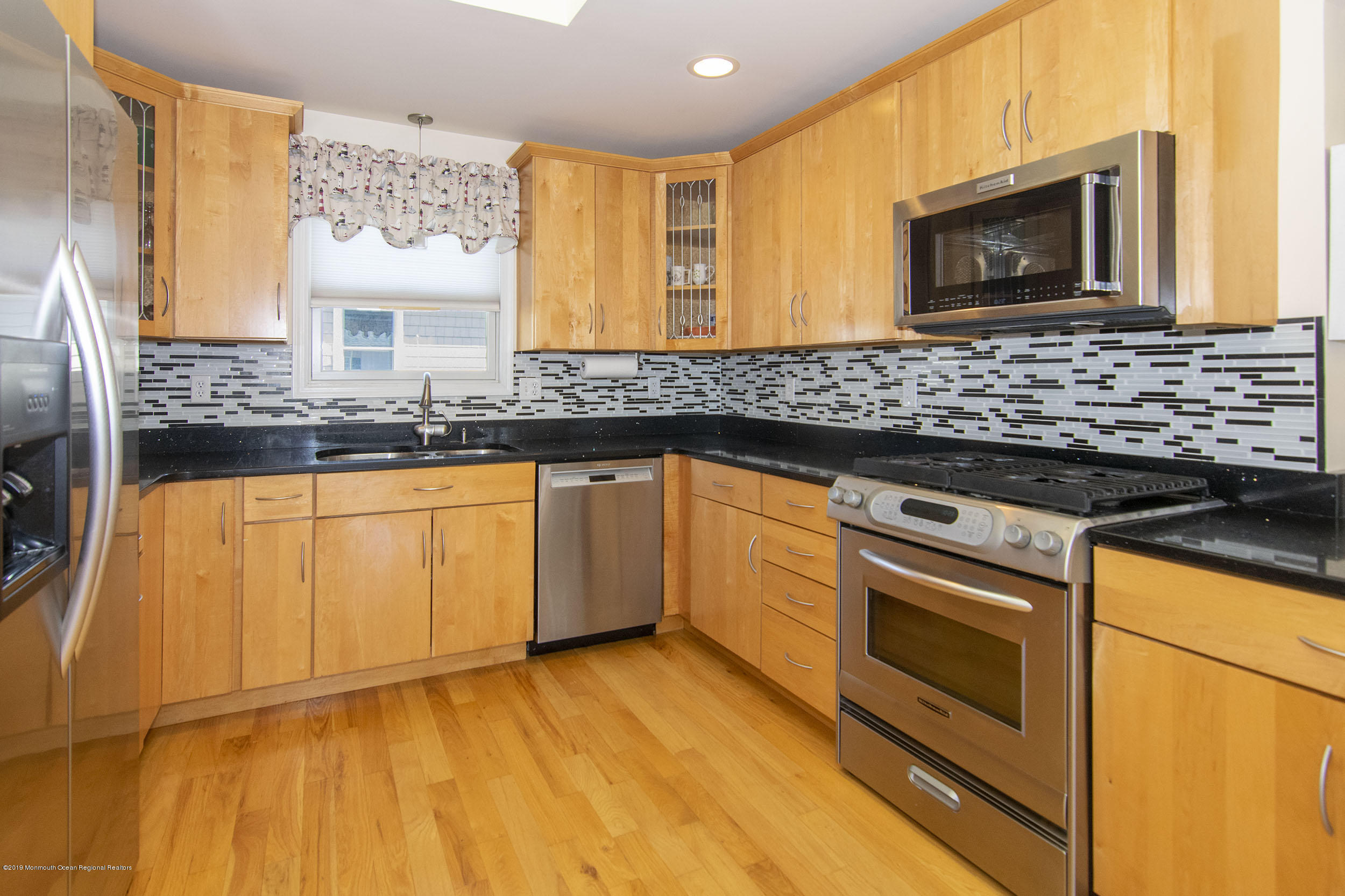 20 Holiday Road Seaside Heights, NJ 08751 - Photo 12 of 42 a kitchen with granite countertop a sink cabinets and stainless steel appliances