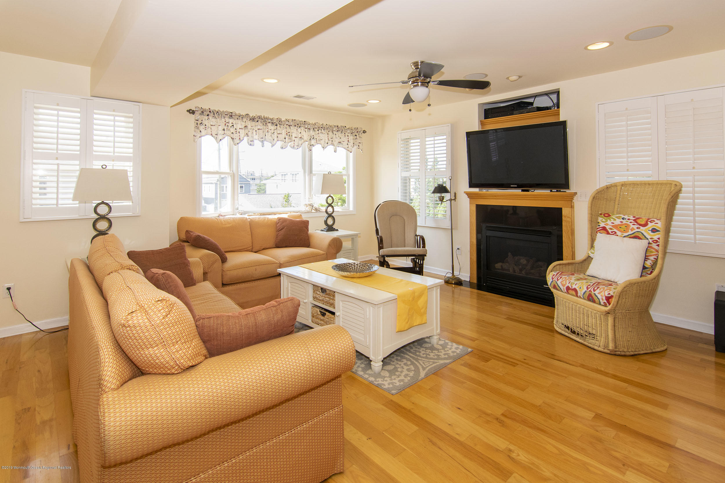 20 Holiday Road Seaside Heights, NJ 08751 - Photo 13 of 42 a living room with furniture a flat screen tv and a fireplace