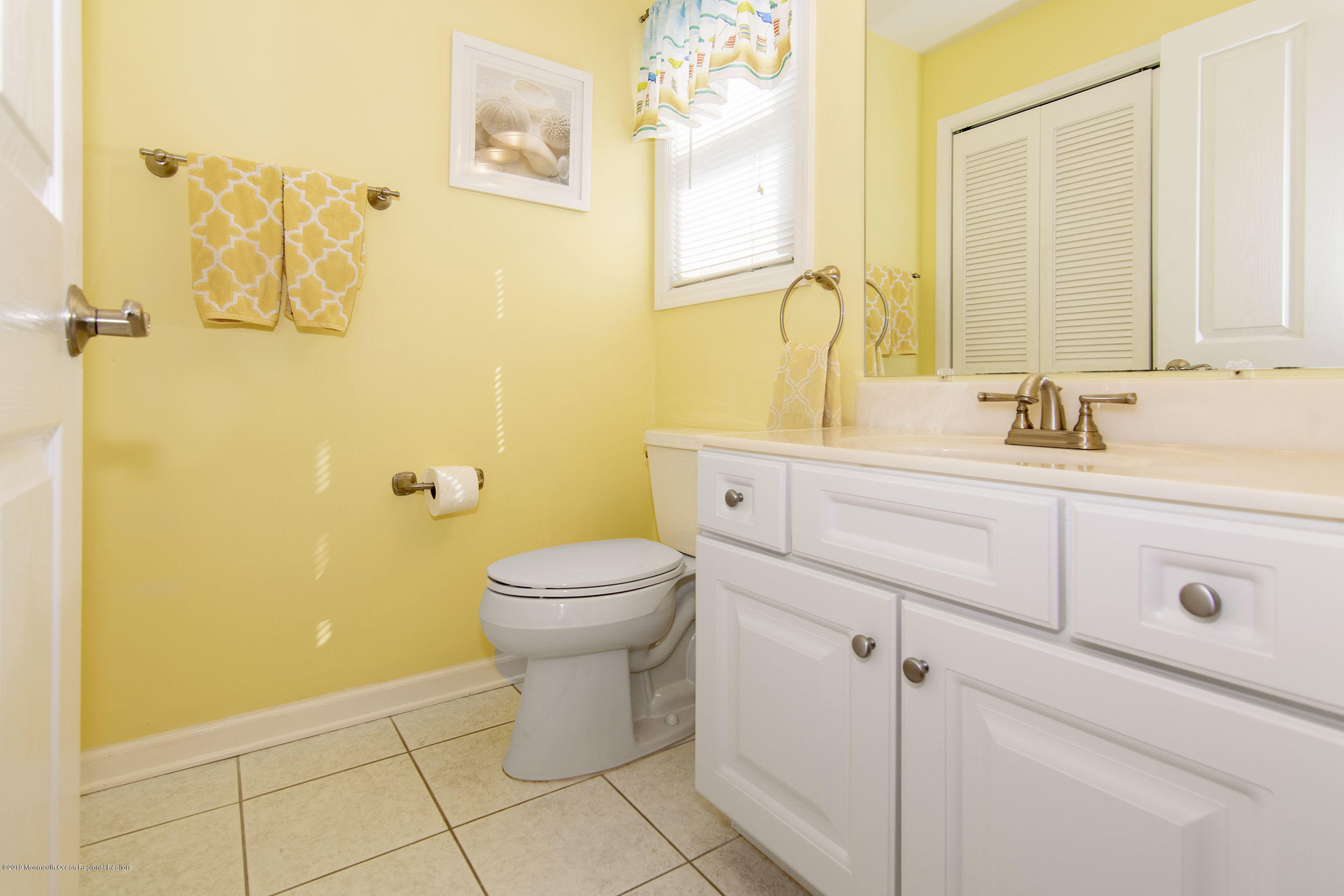 20 Holiday Road Seaside Heights, NJ 08751 - Photo 16 of 42 a bathroom with a toilet sink vanity and mirror