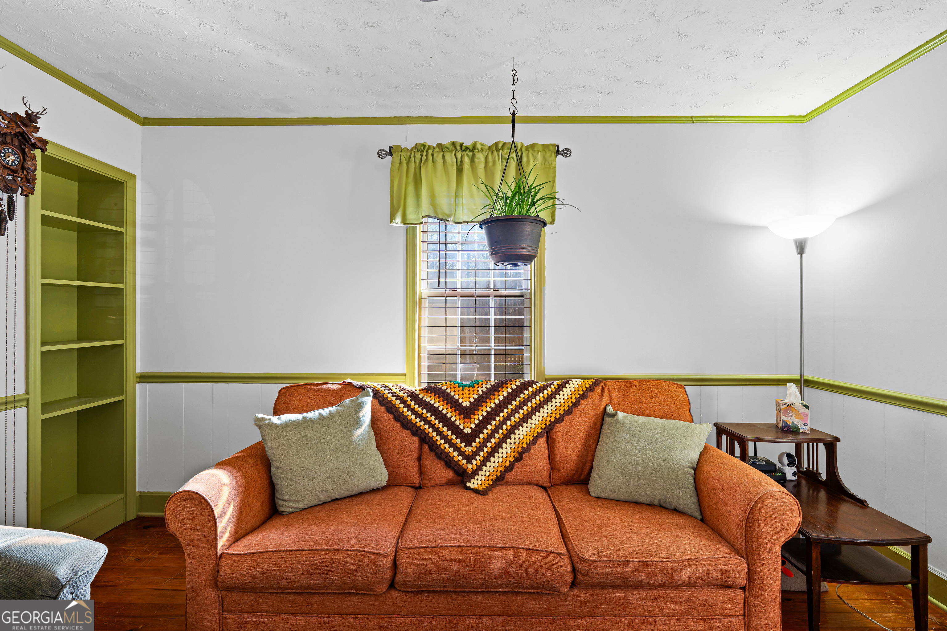 209 Boogers Hill Road Oxford, GA 30054 - Photo 16 of 44 a blue couch sitting in a living room next to a window