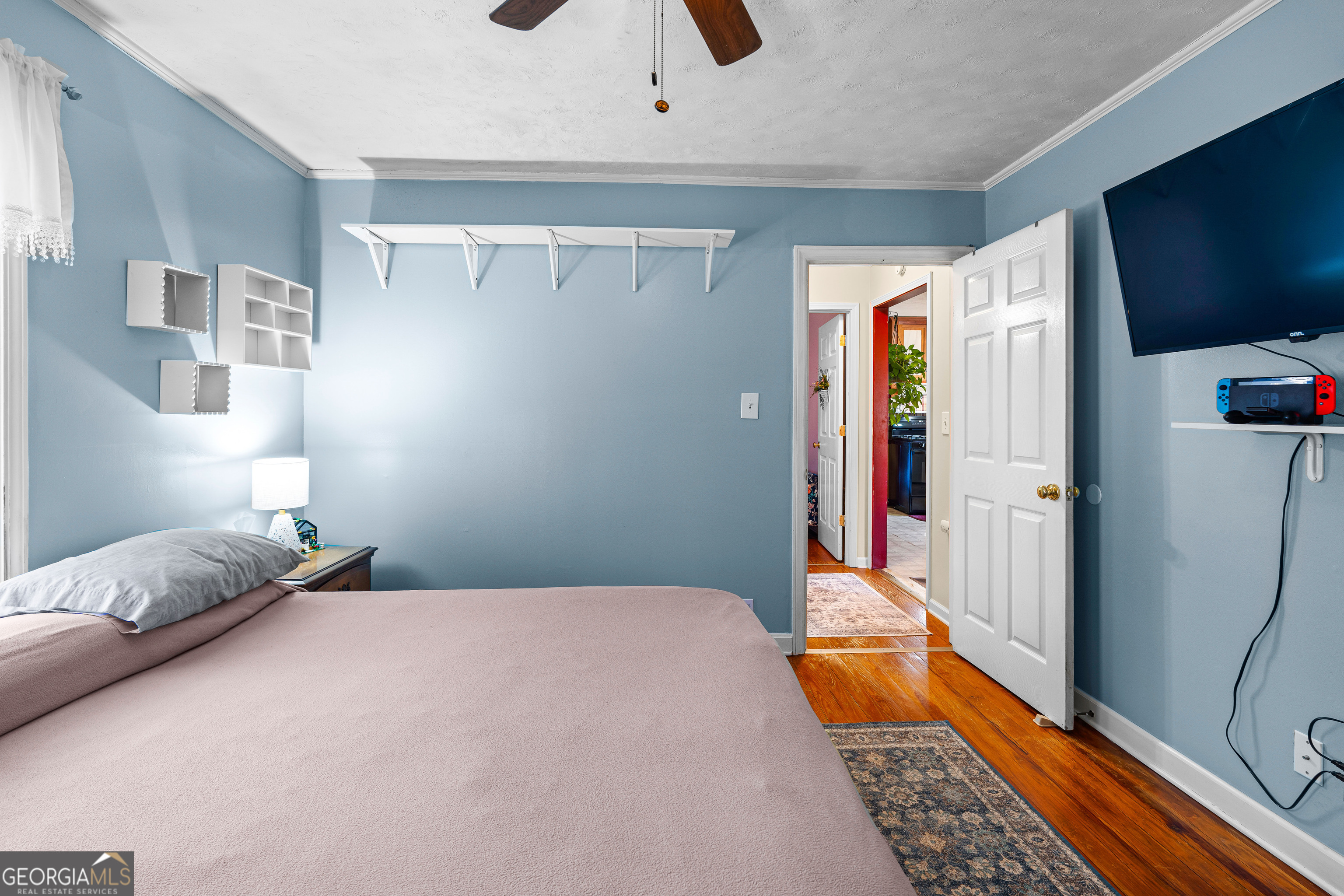 209 Boogers Hill Road Oxford, GA 30054 - Photo 25 of 44 a bedroom with a bed and a flat tv screen on the dresser