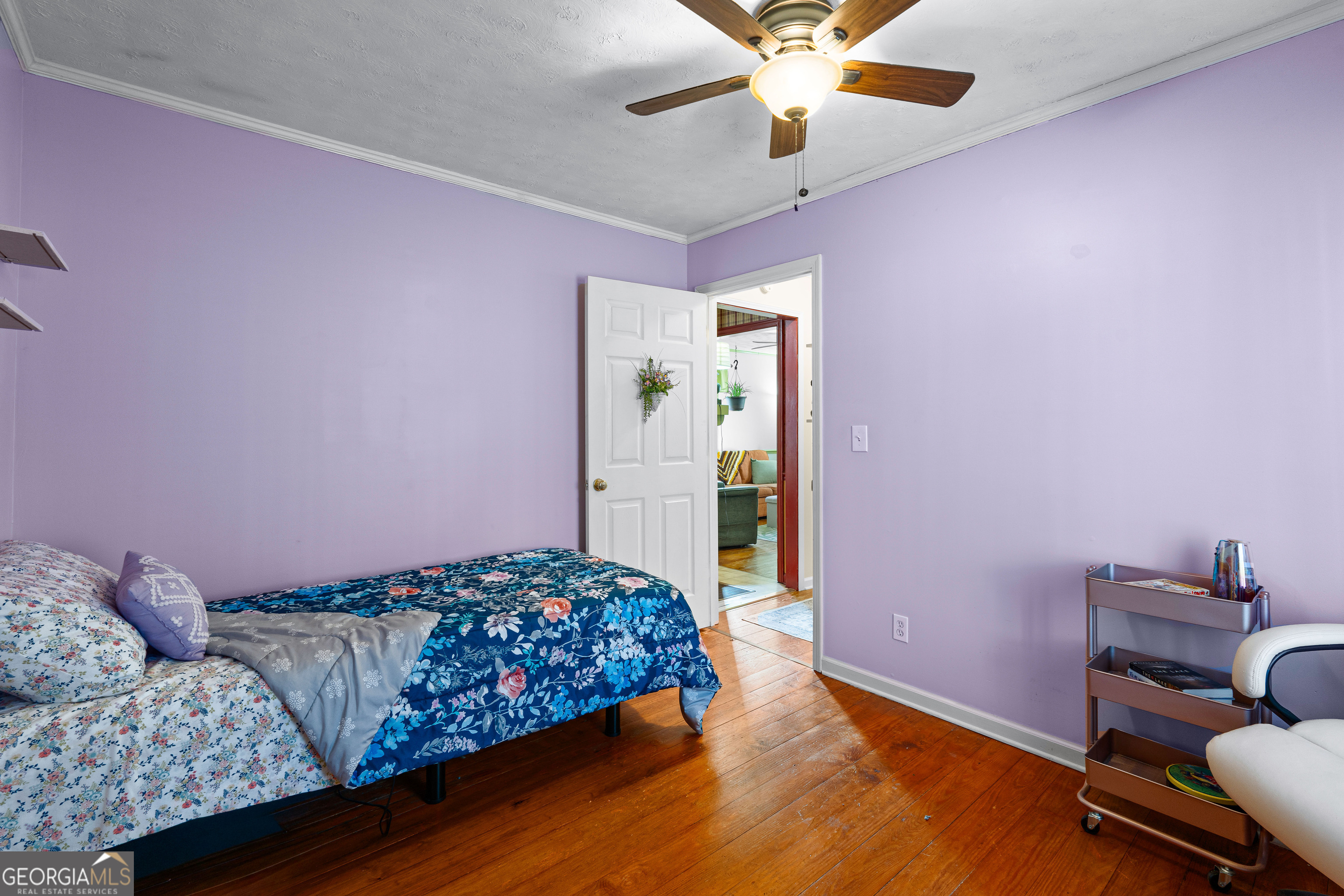 209 Boogers Hill Road Oxford, GA 30054 - Photo 31 of 44 a bedroom with a bed and a chandelier