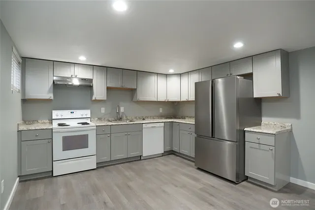 a kitchen with a white cabinets and stainless steel appliances