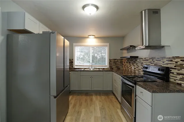 a kitchen with a sink stove and refrigerator