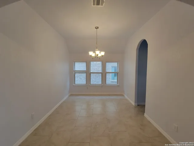 a view of a room with windows and chandelier