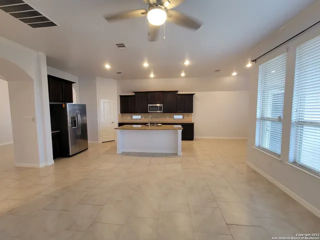a view of kitchen with refrigerator and microwave