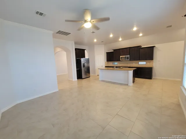a view of kitchen with stainless steel appliances kitchen island microwave and stove