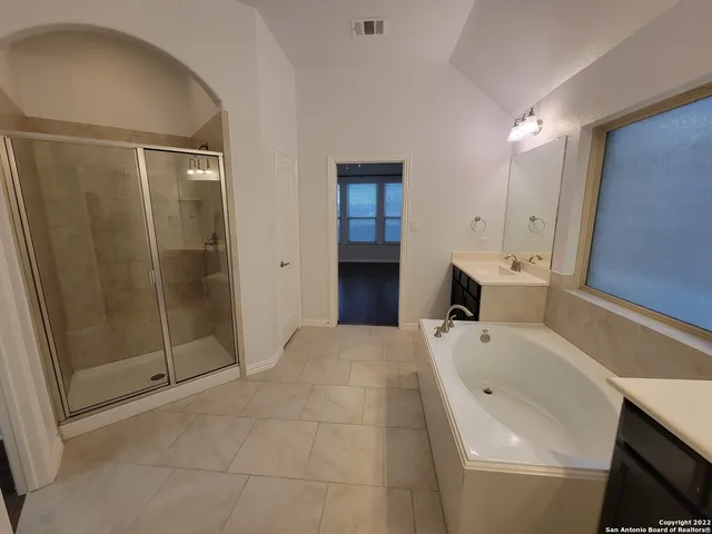 a bathroom with a bathtub and a shower