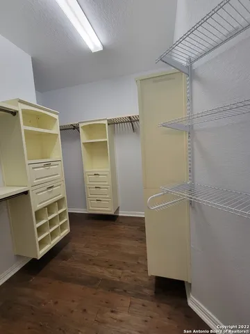 a view of walk in closet with clothes
