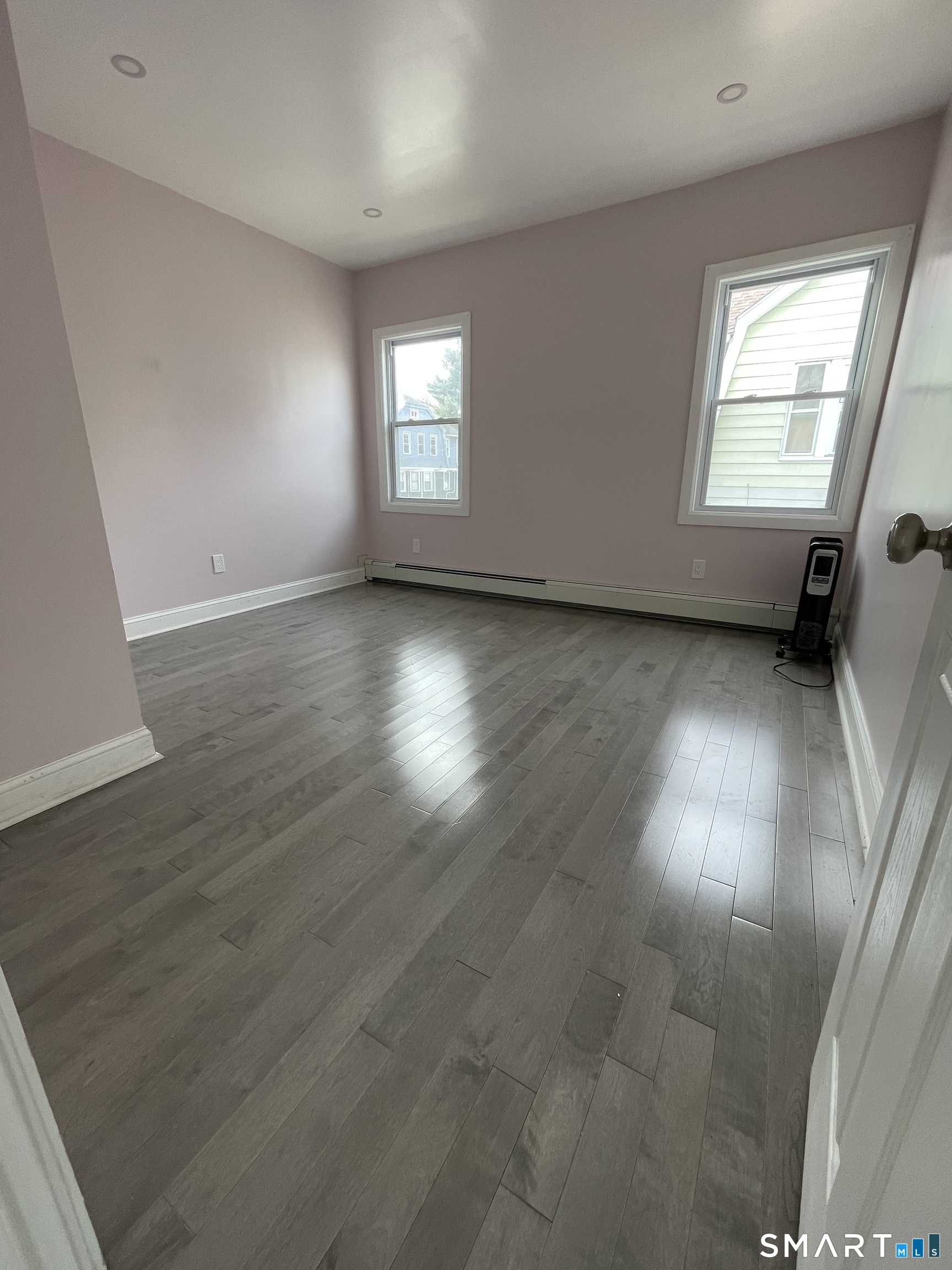 176 Pearl Street Waterbury, CT 06704 - Photo 11 of 19 an empty room with wooden floor and windows