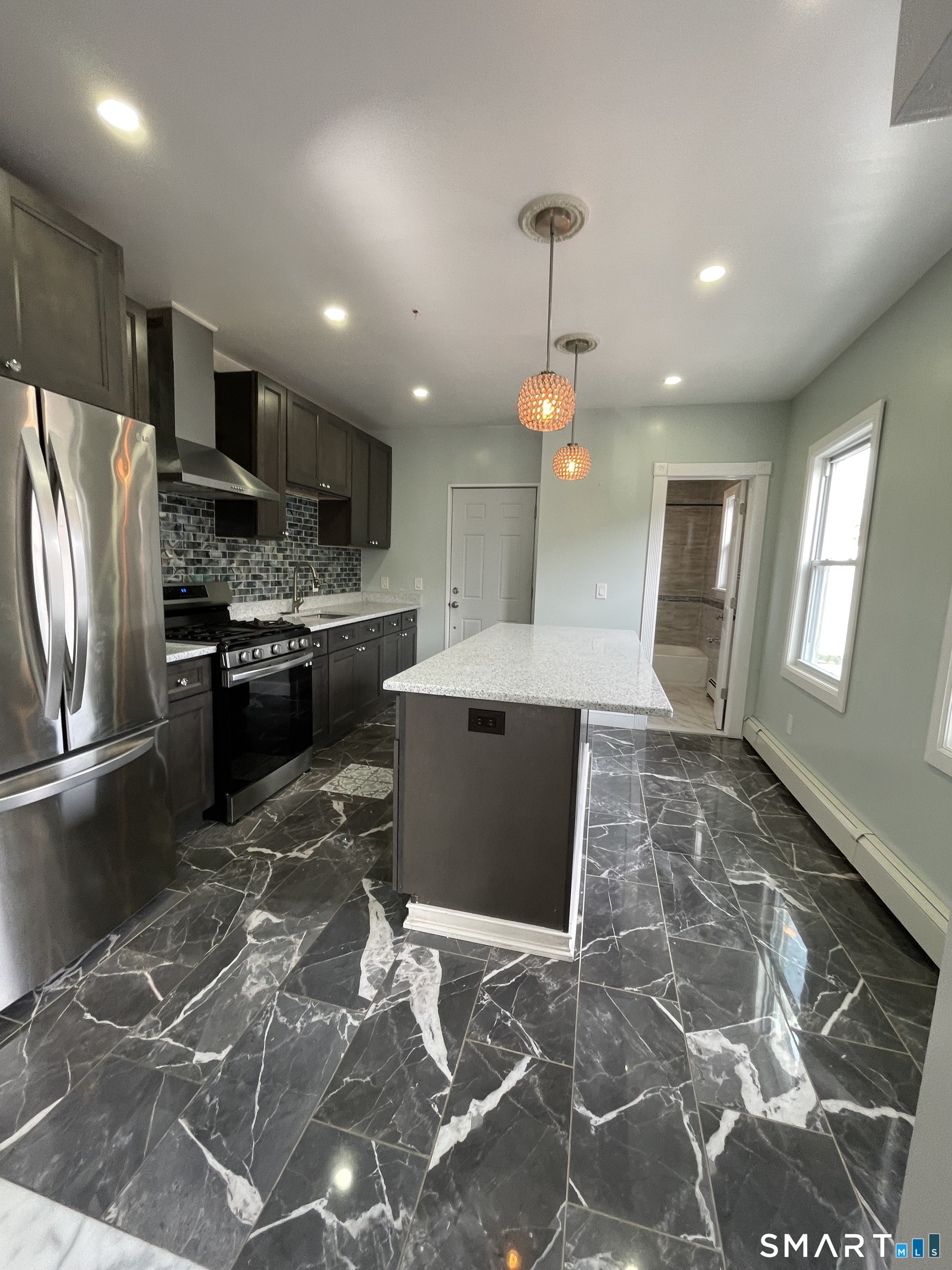 176 Pearl Street Waterbury, CT 06704 - Photo 14 of 19 a open kitchen with stainless steel appliances granite countertop a stove refrigerator and cabinets