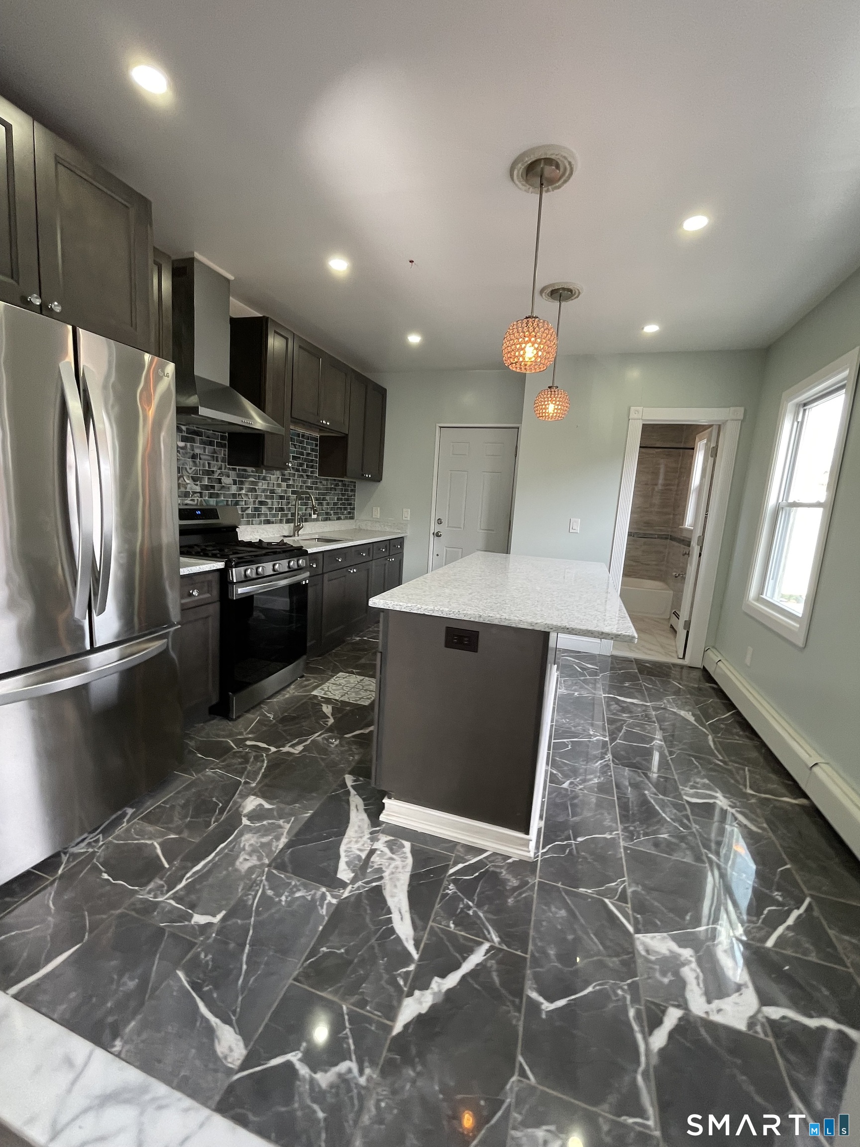 176 Pearl Street Waterbury, CT 06704 - Photo 5 of 19 a kitchen with kitchen island a counter top space appliances and cabinets