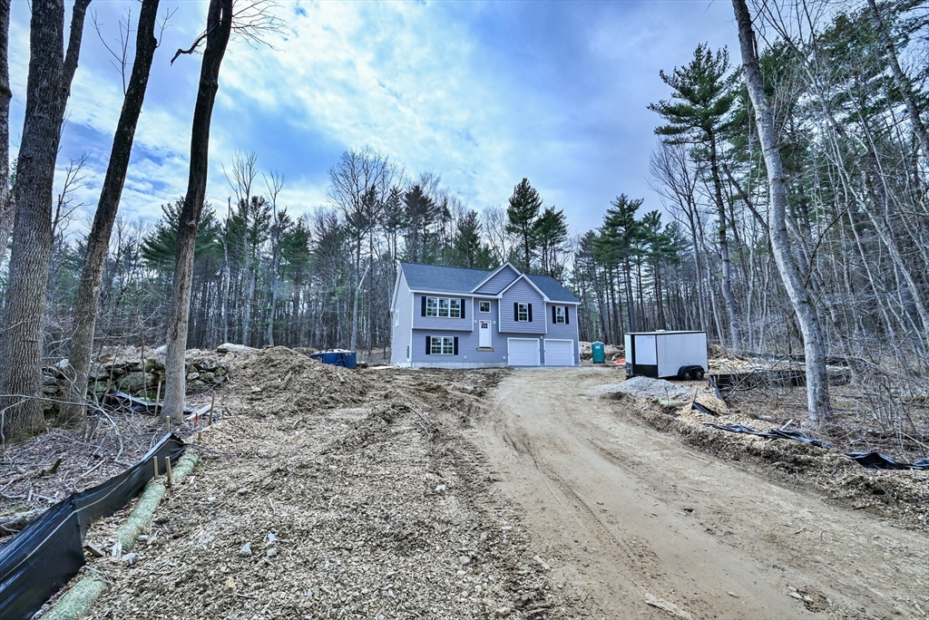86 Ramshorn Road Dudley, MA 01571 - Photo 5 of 33 a view of a backyard with large trees and wooden fence