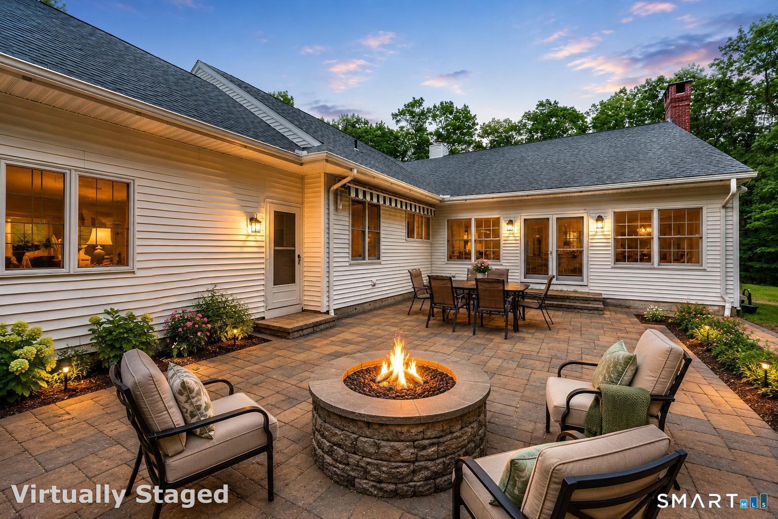 96 Spak Road Willington, CT 06279 - Photo 20 of 40 Stone patio with built-in firepit creates an idyllic setting for outdoor evenings under the stars. Virtually staged with furniture and some added landscaping.