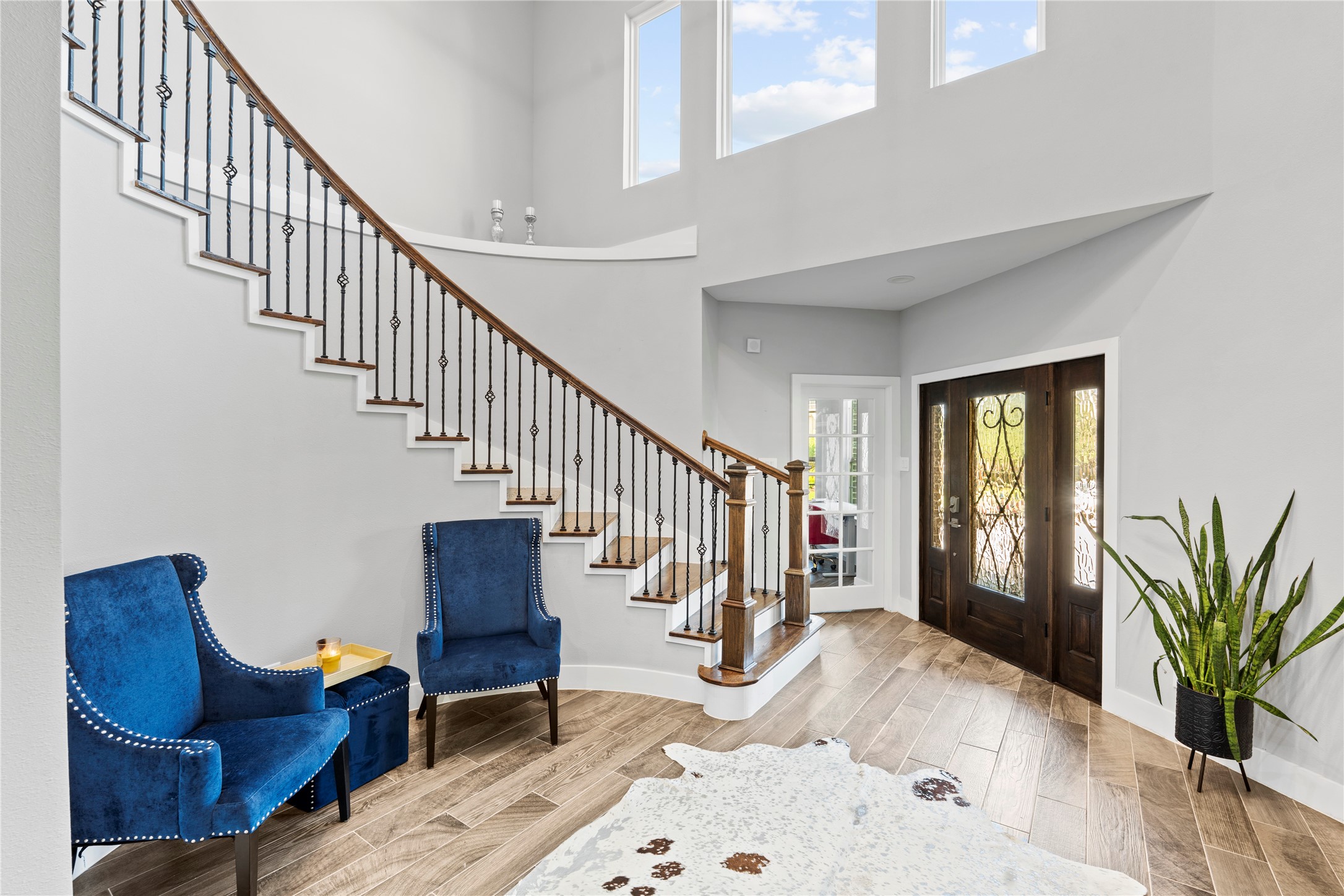 6207 Graff Net Court Spring, TX 77379 - Photo 3 of 49 Beautiful curved staircase with tall windows flooding the entryway with natural light.