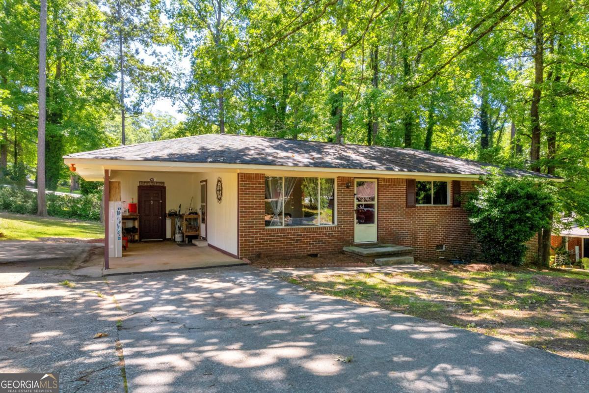 a view of a house with backyard porch and sitting area