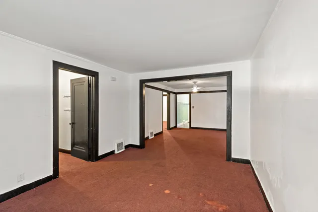 an empty room with windows and closet