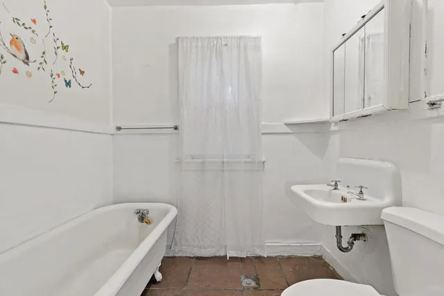 a bathroom with a sink a toilet and bathtub
