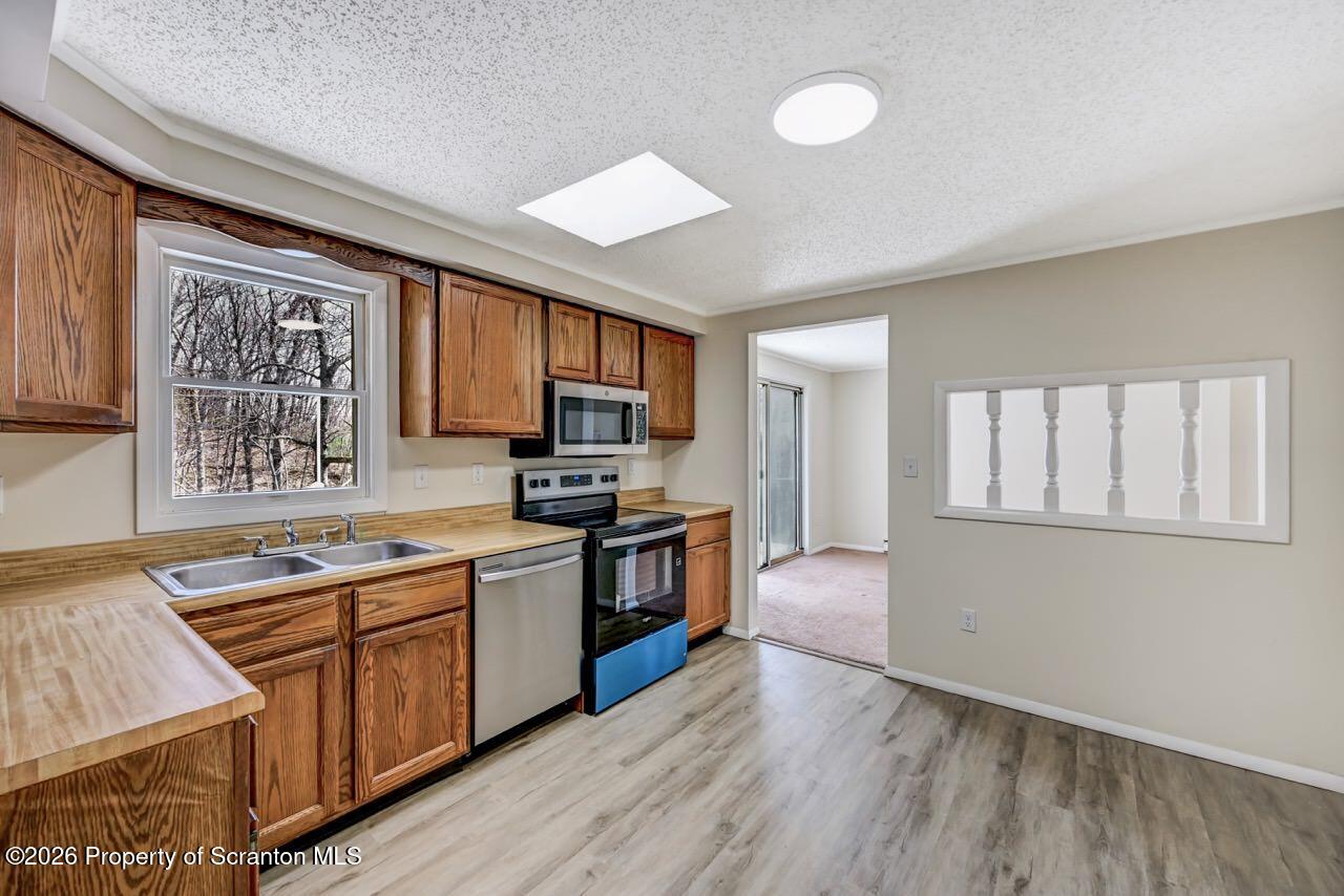 3032 1/2 Division Street Scranton, PA 18504 - Photo 20 of 49 a large kitchen with stainless steel appliances granite countertop a stove and a sink
