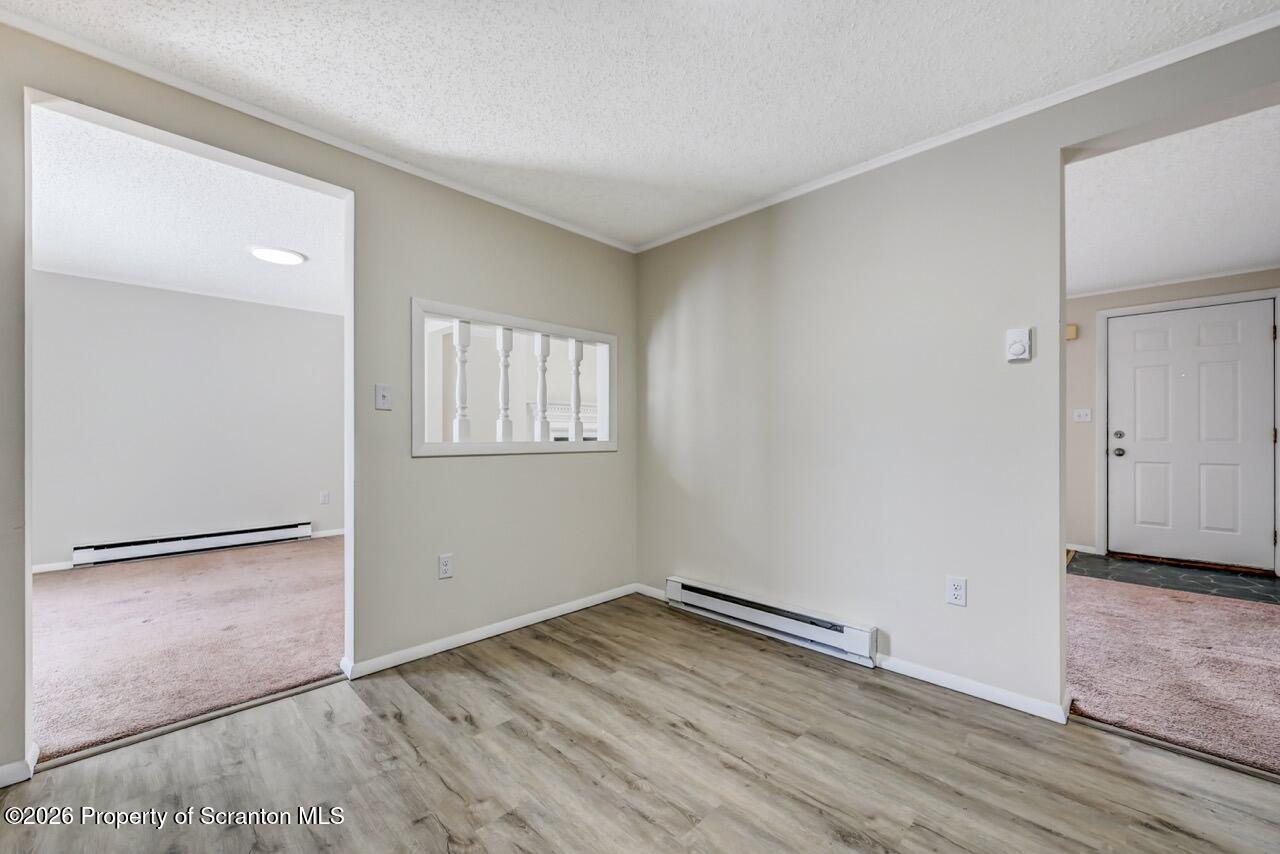 3032 1/2 Division Street Scranton, PA 18504 - Photo 21 of 49 an empty room with wooden floor and windows
