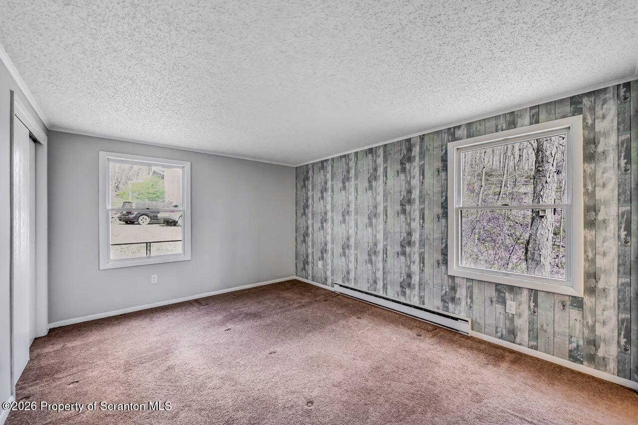 3032 1/2 Division Street Scranton, PA 18504 - Photo 22 of 49 wooden floor in an empty room with a window