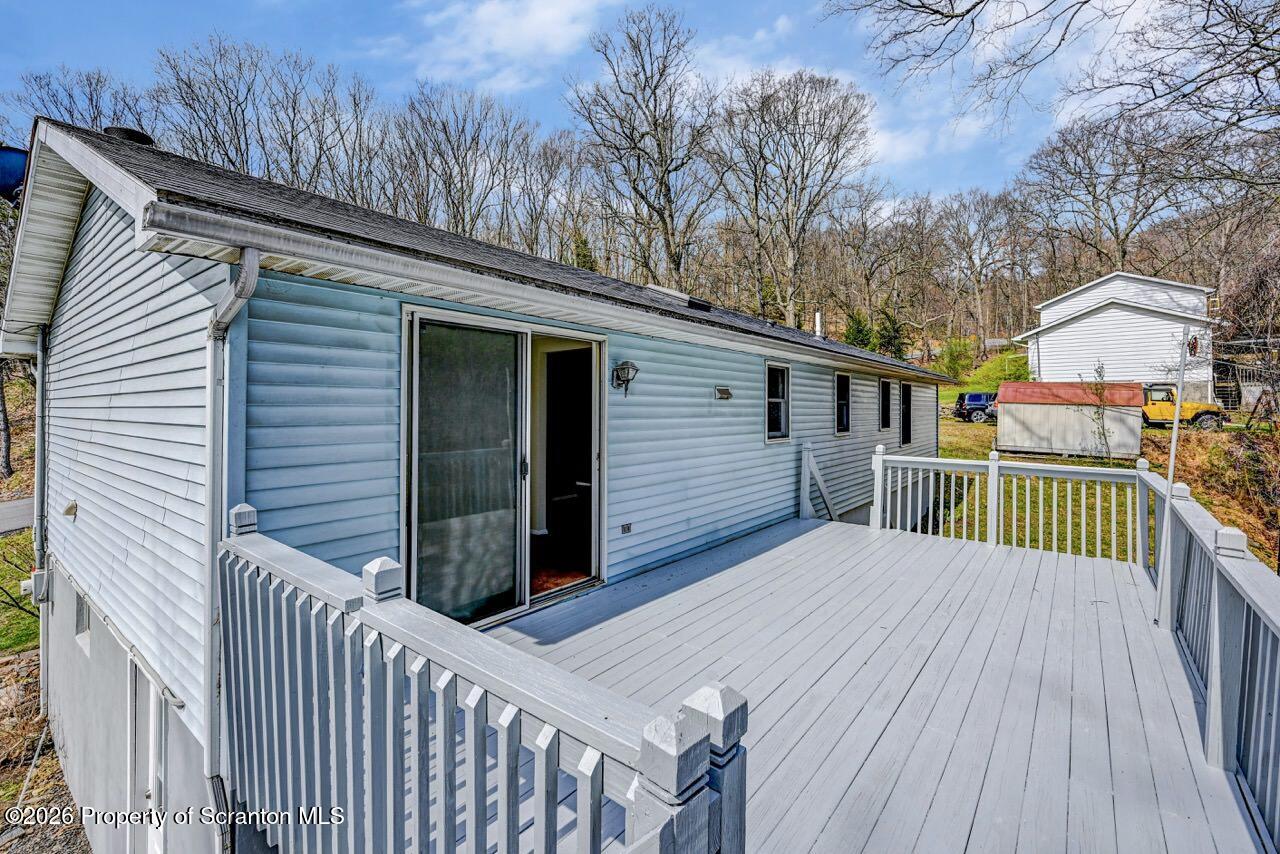 3032 1/2 Division Street Scranton, PA 18504 - Photo 42 of 49 a view of a house with wooden deck front of house