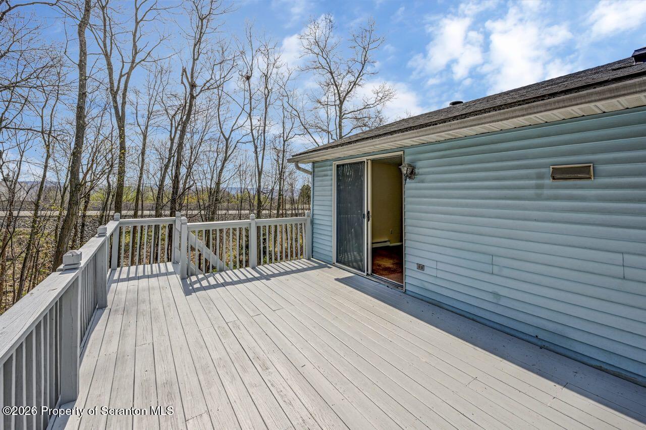 3032 1/2 Division Street Scranton, PA 18504 - Photo 5 of 49 a view of a balcony with wooden floor and fence