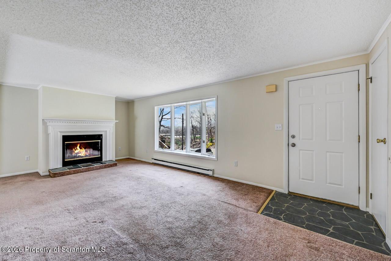 3032 1/2 Division Street Scranton, PA 18504 - Photo 7 of 49 an empty room with windows and fireplace