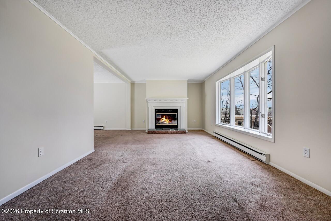 3032 1/2 Division Street Scranton, PA 18504 - Photo 8 of 49 a big room with windows and a fireplace