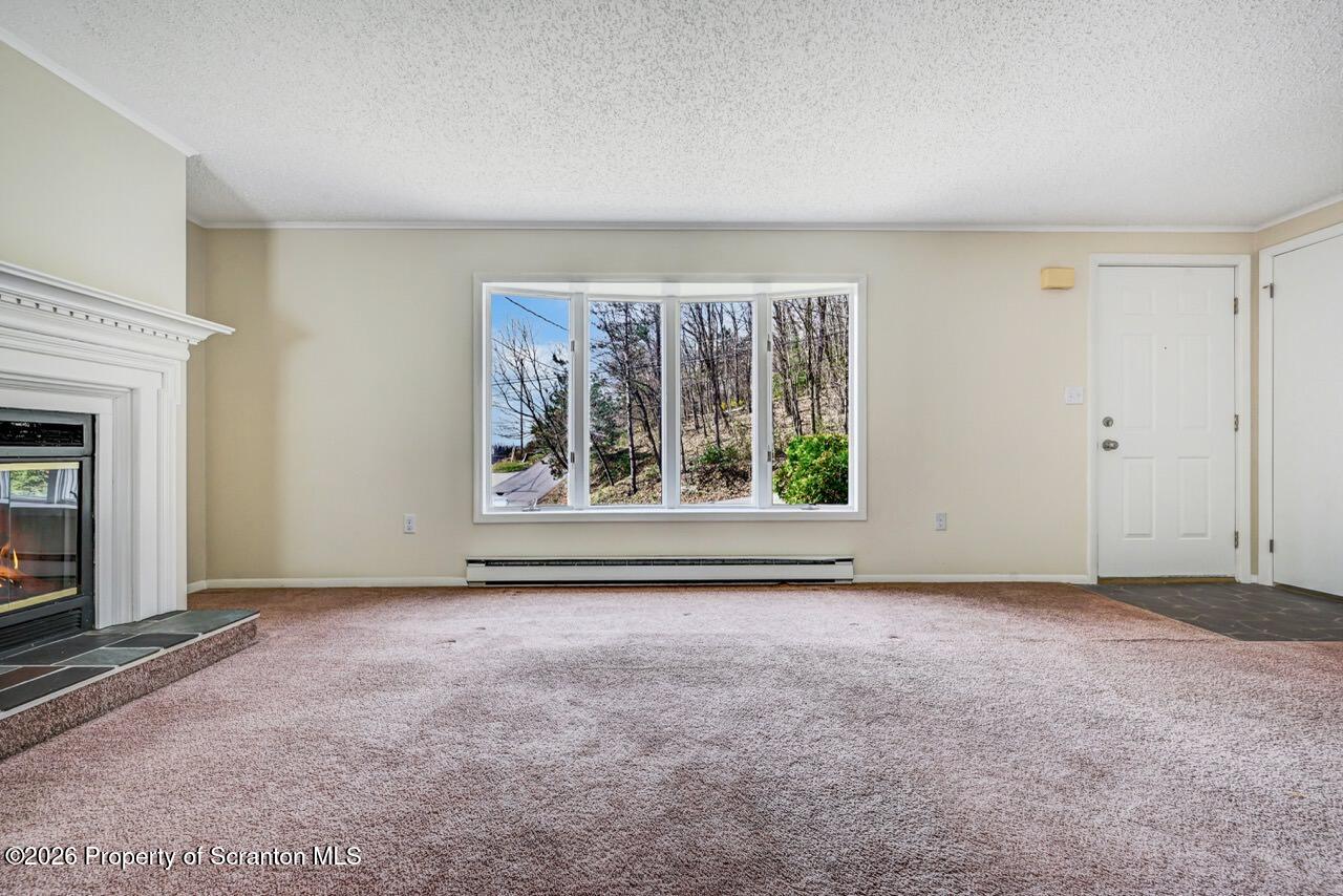 3032 1/2 Division Street Scranton, PA 18504 - Photo 9 of 49 an empty room with windows and fireplace