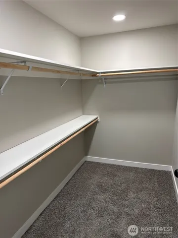 a view of a hallway view with wooden floor and staircase