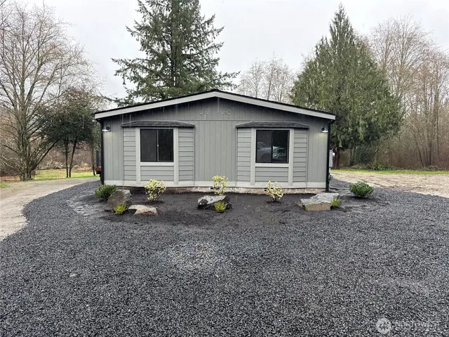 a backyard of a house with barbeque oven table and chairs