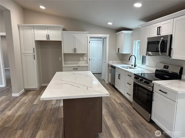 a kitchen with a sink stove and refrigerator
