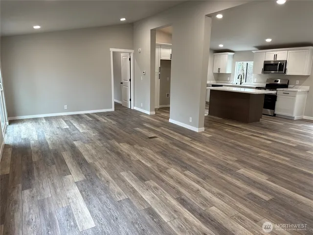 a view of kitchen with wooden floor and electronic appliances