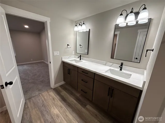 a spacious bathroom with a double vanity sink and mirror