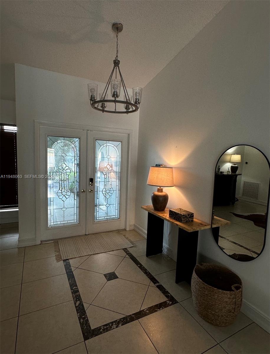 3594 Southwest 69th Avenue Miramar, FL 33023 - Photo 11 of 20 a view of a livingroom with furniture and a chandelier