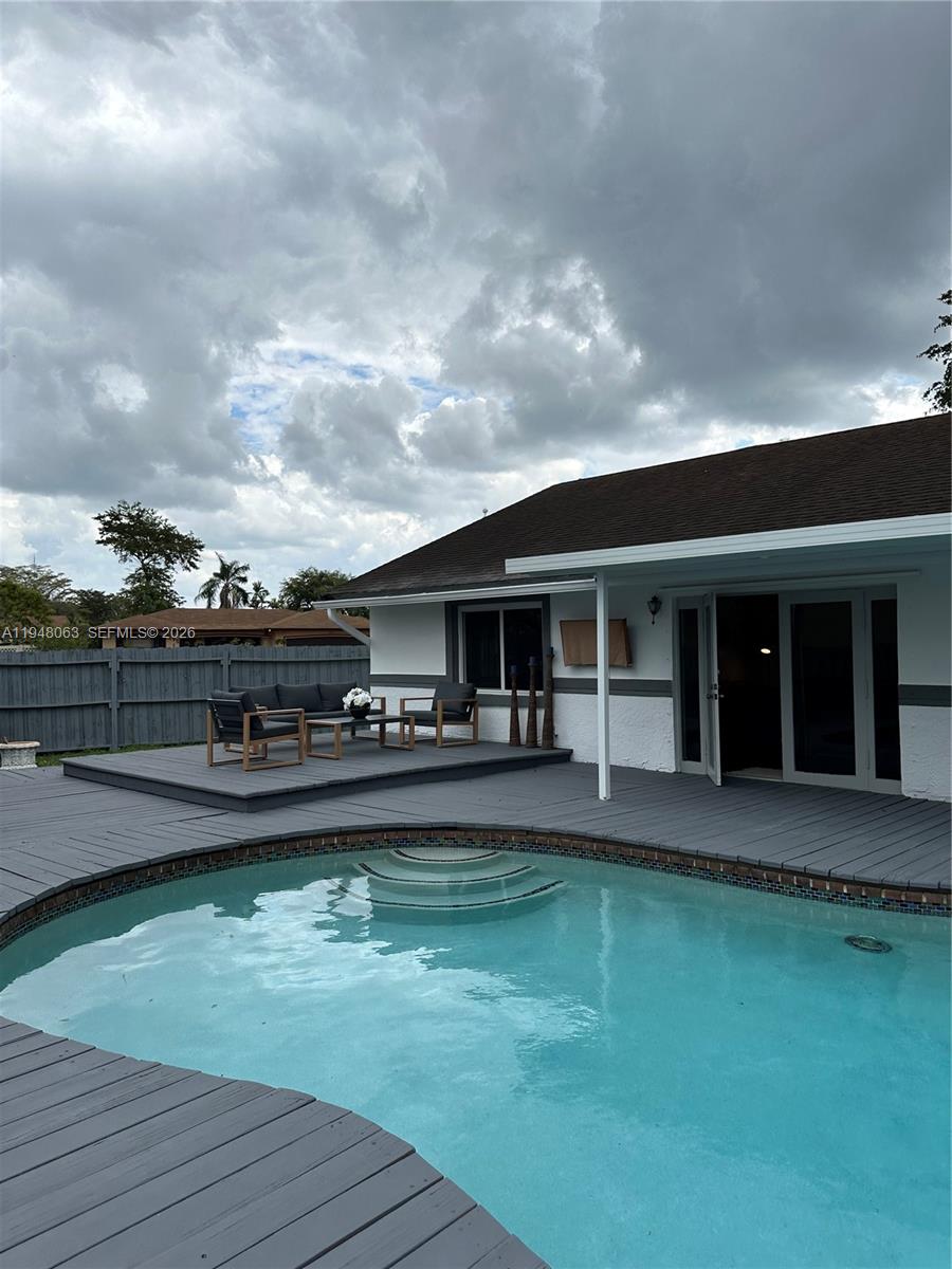 3594 Southwest 69th Avenue Miramar, FL 33023 - Photo 18 of 20 a front view of a house with swimming pool next to a yard