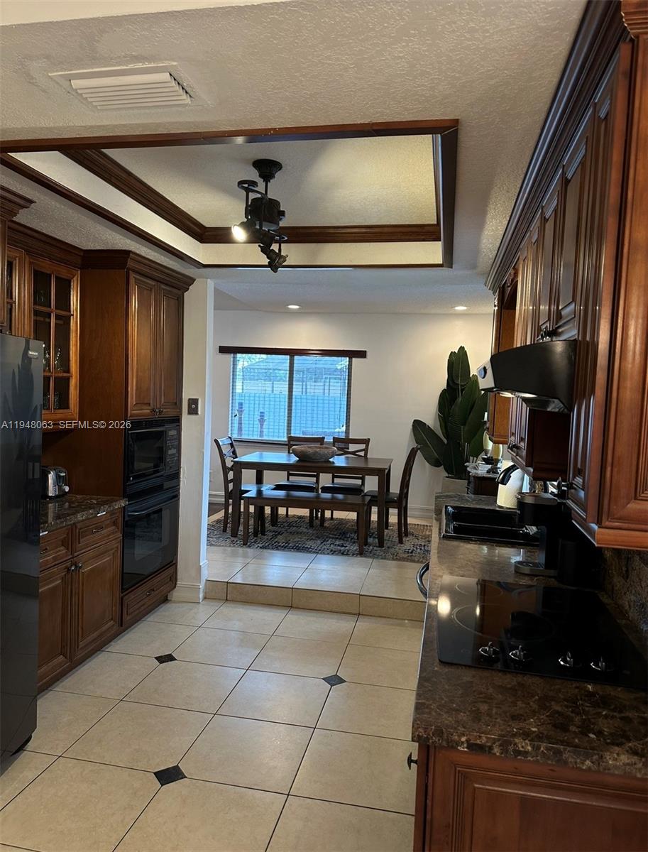 3594 Southwest 69th Avenue Miramar, FL 33023 - Photo 4 of 20 a kitchen with refrigerator and cabinets